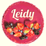 Beautifully decorated red velvet berry birthday cake with vibrant fruits and a glowing 'Leidy' name, adding a touch of sweetness and sparkle.