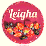 Beautifully decorated red velvet berry birthday cake with vibrant fruits and a glowing 'Leigha' name, adding a touch of sweetness and sparkle.