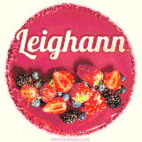 Beautifully decorated red velvet berry birthday cake with vibrant fruits and a glowing 'Leighann' name, adding a touch of sweetness and sparkle.