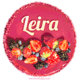 Beautifully decorated red velvet berry birthday cake with vibrant fruits and a glowing 'Leira' name, adding a touch of sweetness and sparkle.