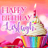 A vibrant birthday GIF featuring a rainbow-colored cupcake topped with white frosting, sprinkles, and a lit candle. The text reads 'Happy Birthday Lesleigh' in bold pink and violet letters with white outline.