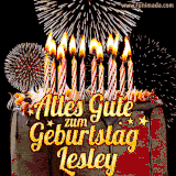 A chocolate birthday cake with glowing candles, the German text 'Alles Gute zum Geburtstag Lesley,' and vibrant fireworks lighting up the background in an animated GIF.