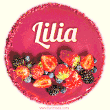 Beautifully decorated red velvet berry birthday cake with vibrant fruits and a glowing 'Lilia' name, adding a touch of sweetness and sparkle.