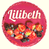 Beautifully decorated red velvet berry birthday cake with vibrant fruits and a glowing 'Lilibeth' name, adding a touch of sweetness and sparkle.
