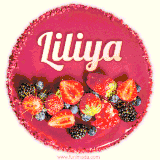 Beautifully decorated red velvet berry birthday cake with vibrant fruits and a glowing 'Liliya' name, adding a touch of sweetness and sparkle.