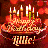 Beautifully decorated red velvet berry birthday cake with vibrant fruits and a glowing 'Lillie' name, adding a touch of sweetness and sparkle.