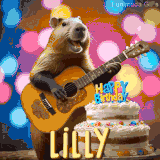 Animated birthday GIF showing a capybara playing guitar and singing beside a birthday cake with the name Lilly in large letters and colorful bokeh lights in the background.