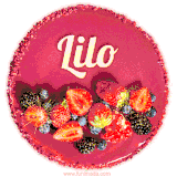 Beautifully decorated red velvet berry birthday cake with vibrant fruits and a glowing 'Lilo' name, adding a touch of sweetness and sparkle.