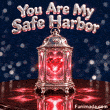 A comforting animated romantic GIF displaying a decorative silver vintage lantern with a glowing ruby crystal heart inside casting light reflections above the phrase You Are My Safe Harbor.