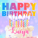 A vibrant animated name GIF with the words 'Happy Birthday Lucija' with colorful candles on a creamy cake. The background sparkles with pastel shades, adding a festive touch.