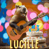 Animated birthday GIF showing a capybara playing guitar and singing beside a birthday cake with the name Lucille in large letters and colorful bokeh lights in the background.