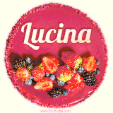 Beautifully decorated red velvet berry birthday cake with vibrant fruits and a glowing 'Lucina' name, adding a touch of sweetness and sparkle.