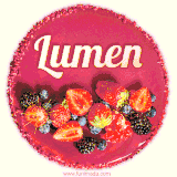 Beautifully decorated red velvet berry birthday cake with vibrant fruits and a glowing 'Lumen' name, adding a touch of sweetness and sparkle.