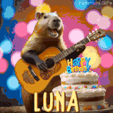 Animated birthday GIF showing a capybara playing guitar and singing beside a birthday cake with the name Luna in large letters and colorful bokeh lights in the background.