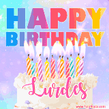 A vibrant animated name GIF with the words 'Happy Birthday Lurdes' with colorful candles on a creamy cake. The background sparkles with pastel shades, adding a festive touch.
