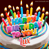 A colorful birthday cake topped with lit candles, with the words 'Happy Birthday Lux' in bold glowing letters on a burgundy background. Animated flames add a festive touch.