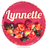 Beautifully decorated red velvet berry birthday cake with vibrant fruits and a glowing 'Lynnette' name, adding a touch of sweetness and sparkle.