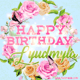 A charming animated GIF featuring 'Happy Birthday Lyudmyla' in pink and green text, surrounded by delicate roses, leaves, and fluttering butterflies on a soft light blue pastel background.