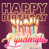 A colorful birthday cake topped with lit candles, with the words 'Happy Birthday Lyudmyla' in bold glowing letters on a burgundy background. Animated flames add a festive touch.