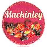 Beautifully decorated red velvet berry birthday cake with vibrant fruits and a glowing 'Mackinley' name, adding a touch of sweetness and sparkle.