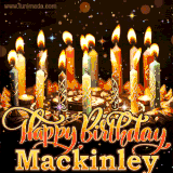 A glowing personalized birthday GIF with name Mackinley featuring lit candles with intricate designs, warm lighting, and the text 'Happy Birthday' in an elegant font.