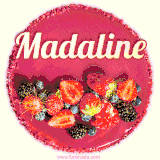 Beautifully decorated red velvet berry birthday cake with vibrant fruits and a glowing 'Madaline' name, adding a touch of sweetness and sparkle.