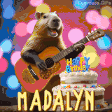 Animated birthday GIF showing a capybara playing guitar and singing beside a birthday cake with the name Madalyn in large letters and colorful bokeh lights in the background.