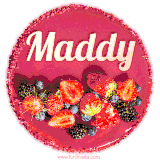 Beautifully decorated red velvet berry birthday cake with vibrant fruits and a glowing 'Maddy' name, adding a touch of sweetness and sparkle.