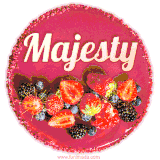 Beautifully decorated red velvet berry birthday cake with vibrant fruits and a glowing 'Majesty' name, adding a touch of sweetness and sparkle.