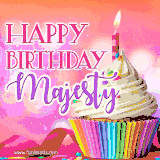 A vibrant birthday GIF featuring a rainbow-colored cupcake topped with white frosting, sprinkles, and a lit candle. The text reads 'Happy Birthday Majesty' in bold pink and violet letters with white outline.