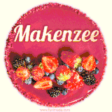 Beautifully decorated red velvet berry birthday cake with vibrant fruits and a glowing 'Makenzee' name, adding a touch of sweetness and sparkle.
