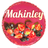 Beautifully decorated red velvet berry birthday cake with vibrant fruits and a glowing 'Makinley' name, adding a touch of sweetness and sparkle.