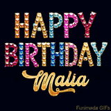 Vibrant luxury birthday greeting card for Malia, showing glittering gemstone letters and golden calligraphy on a dark background with twinkling shine effects.