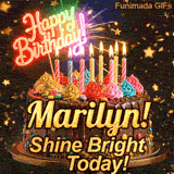 Festive chocolate cake GIF with the name Marilyn! written on the dark glaze under flickering candles.