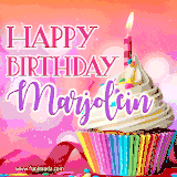 A vibrant birthday GIF featuring a rainbow-colored cupcake topped with white frosting, sprinkles, and a lit candle. The text reads 'Happy Birthday Marjolein' in bold pink and violet letters with white outline.