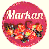 Beautifully decorated red velvet berry birthday cake with vibrant fruits and a glowing 'Markan' name, adding a touch of sweetness and sparkle.