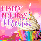 A vibrant birthday GIF featuring a rainbow-colored cupcake topped with white frosting, sprinkles, and a lit candle. The text reads 'Happy Birthday Markan' in bold pink and violet letters with white outline.