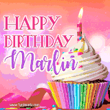 A vibrant birthday GIF featuring a rainbow-colored cupcake topped with white frosting, sprinkles, and a lit candle. The text reads 'Happy Birthday Marlin' in bold pink and violet letters with white outline.