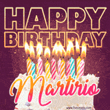 A colorful birthday cake topped with lit candles, with the words 'Happy Birthday Martirio' in bold glowing letters on a burgundy background. Animated flames add a festive touch.