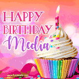 A vibrant birthday GIF featuring a rainbow-colored cupcake topped with white frosting, sprinkles, and a lit candle. The text reads 'Happy Birthday Media' in bold pink and violet letters with white outline.