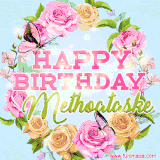 A charming animated GIF featuring 'Happy Birthday Methoataske' in pink and green text, surrounded by delicate roses, leaves, and fluttering butterflies on a soft light blue pastel background.