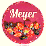 Beautifully decorated red velvet berry birthday cake with vibrant fruits and a glowing 'Meyer' name, adding a touch of sweetness and sparkle.