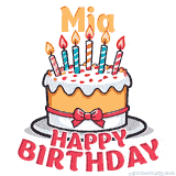 Cartoon birthday cake with a red bow, glowing candles, and 'Mia Happy Birthday' text in bold animated style.