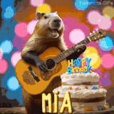 Animated birthday GIF showing a capybara playing guitar and singing beside a birthday cake with the name Mia in large letters and colorful bokeh lights in the background.