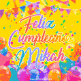 A bright and festive GIF with the text 'Feliz Cumpleaños Mikah' in Spanish in colorful fonts, surrounded by confetti, balloons, and festive banners on a vibrant yellow background.