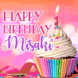 A vibrant birthday GIF featuring a rainbow-colored cupcake topped with white frosting, sprinkles, and a lit candle. The text reads 'Happy Birthday Misaki' in bold pink and violet letters with white outline.