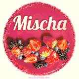 Beautifully decorated red velvet berry birthday cake with vibrant fruits and a glowing 'Mischa' name, adding a touch of sweetness and sparkle.
