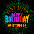 A colorful animated GIF featuring the text 'Happy Birthday Mitchell!' in rainbow colors with a dynamic iridescent firework display in the background.