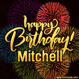 A vibrant display of multicolor fireworks with the text 'Happy Birthday Mitchell' written in gold, glowing beautifully in front of the explosive background.