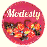 Beautifully decorated red velvet berry birthday cake with vibrant fruits and a glowing 'Modesty' name, adding a touch of sweetness and sparkle.